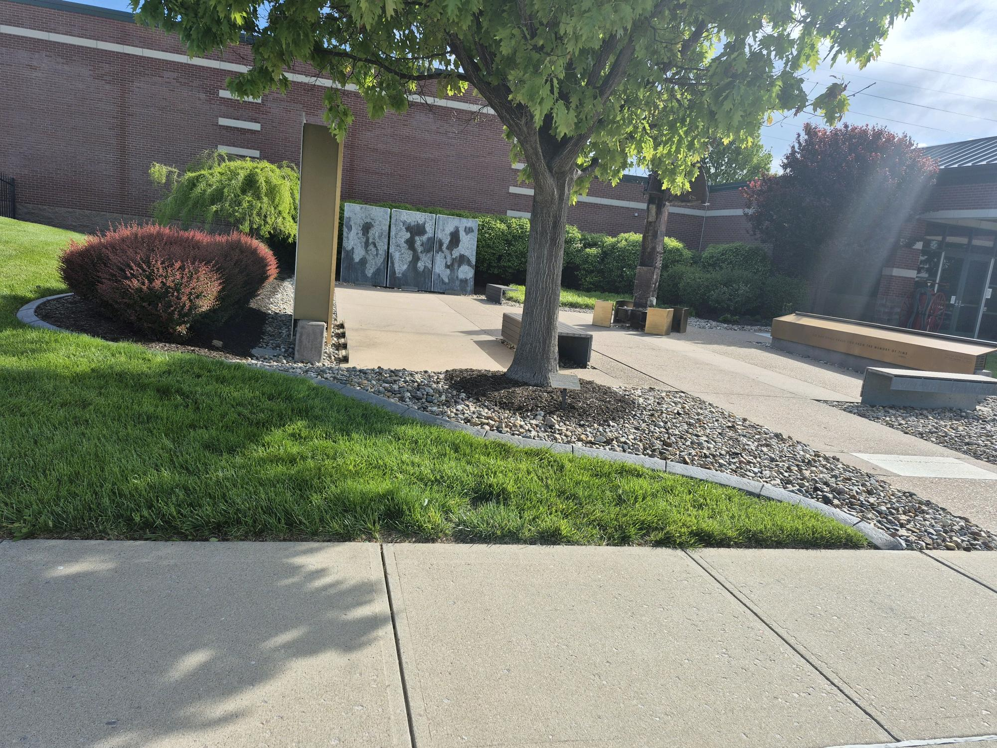 Landscaped municipal plaza with river rock beds and ornamental plantings, Overland Park